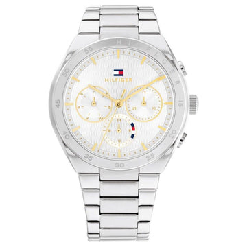 Γυναικείο ρολόι Tommy Hilfiger Carrie 1782573, με μπρασελέ σε ασημί χρώμα από ανοξείδωτο ατσάλι και λευκό καντράν με χρονογράφους και δείκτες σε χρυσό χρώμα.